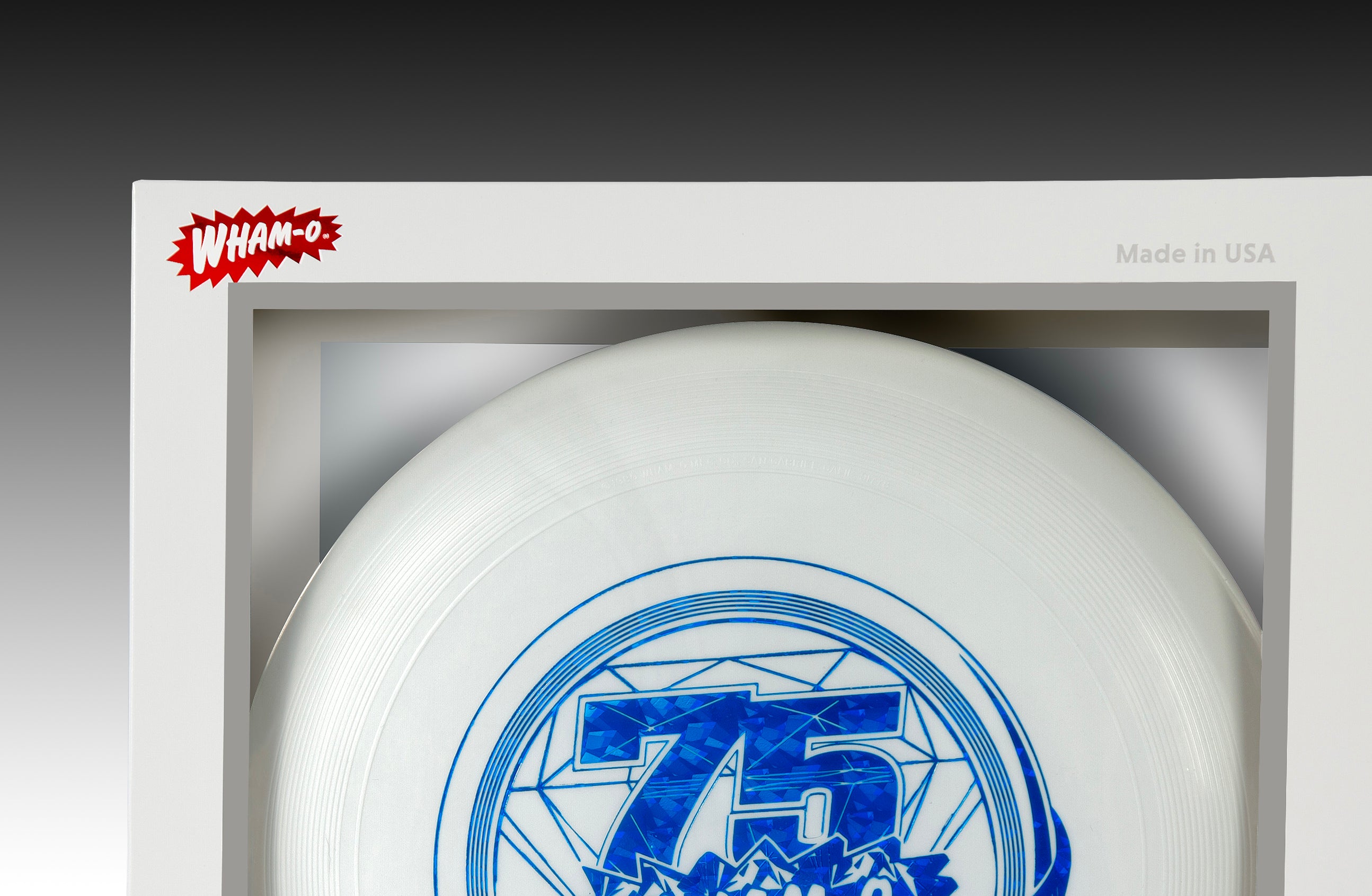 White Frisbee disc in packaging, blue 75th anniversary design, Wham-O logo, Made in USA