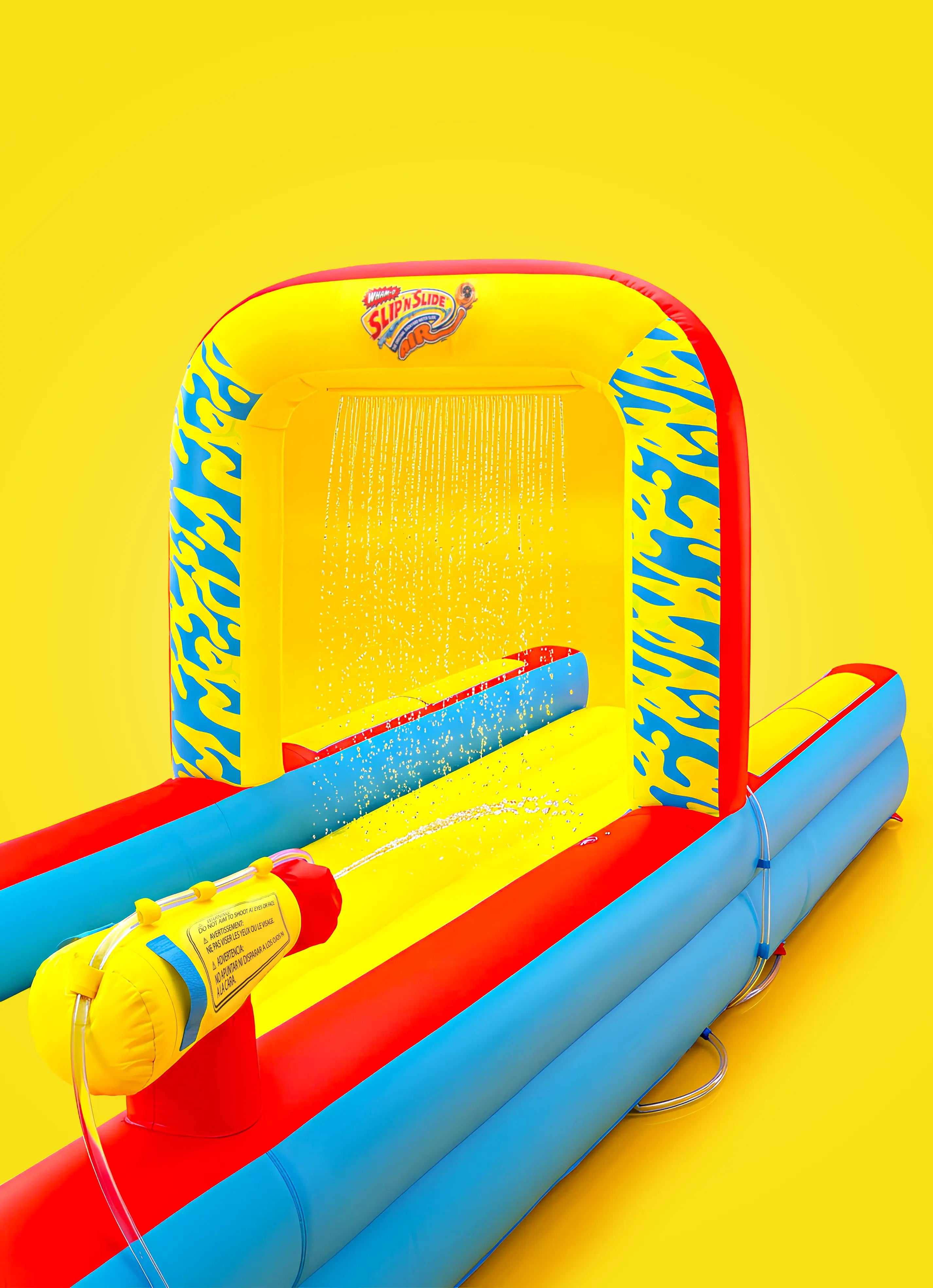 Inflatable Slip 'n Slide with water sprayers, yellow and blue design, on yellow background