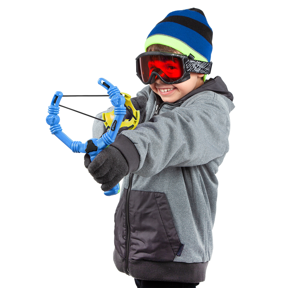 Smiling child in winter clothes using Wham-O snowball slingshot toy outdoors