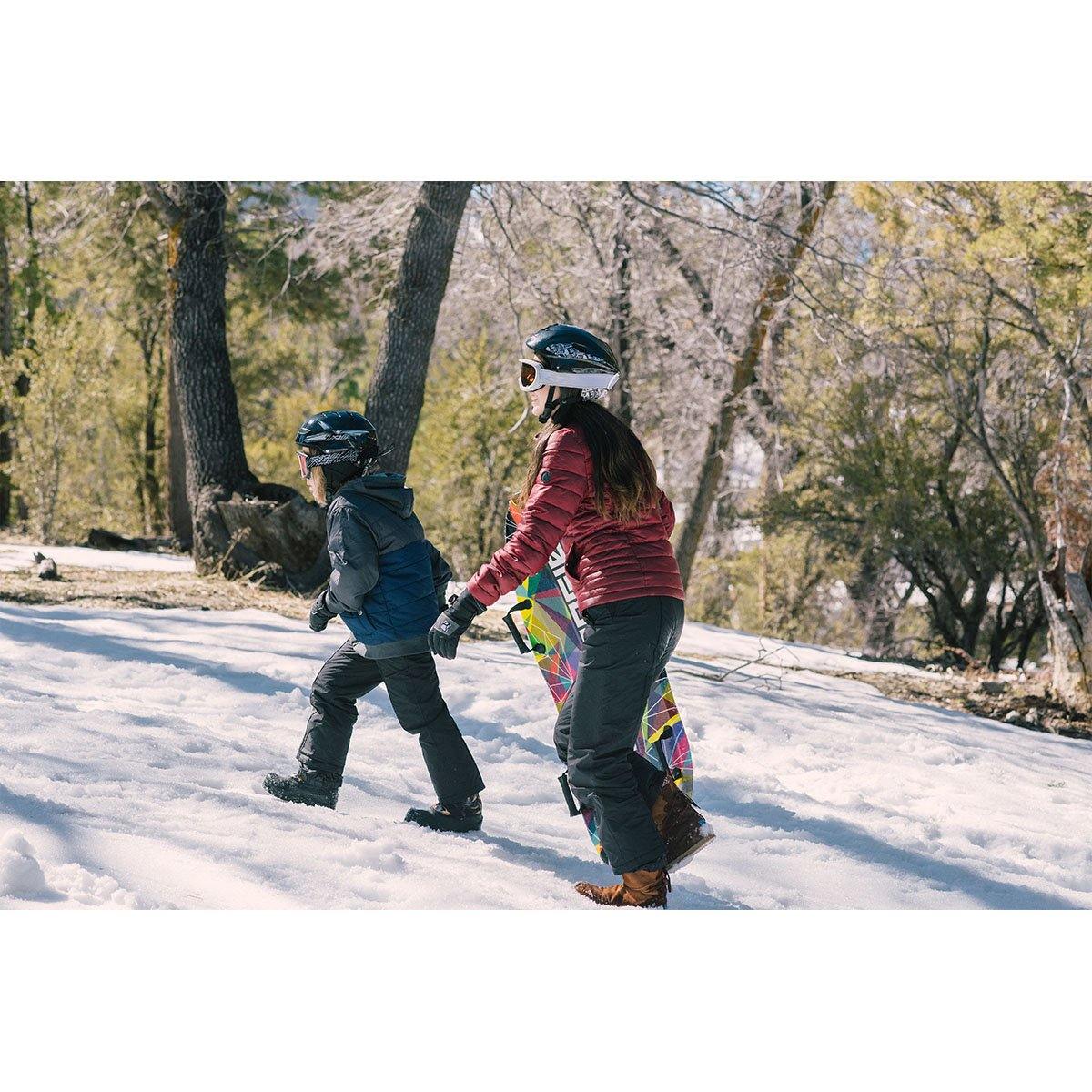 Children are sliding down the snow hill with Wham-O Snowboogie® Alpine Rocket 48"