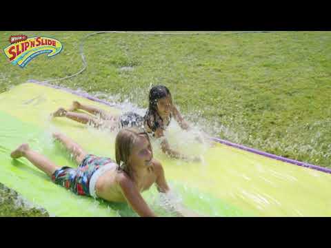 Children are sliding with Wham-O Slip 'N Slide® Surf Rider Double