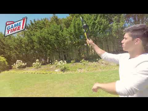 Two men are playing with Wham-O Game Time! Trac-Ball® Classic in the backyard happily