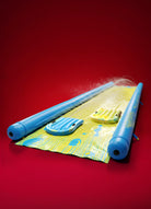 Colorful inflatable slip and slide water toy with dual lanes and splash features on red background