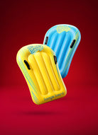Two inflatable Slip 'n Slide boogie boards, one yellow and one blue, on a red background.