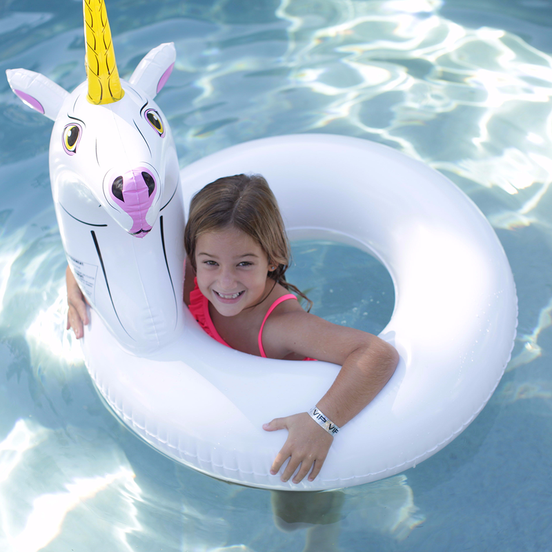 The child is playing with the Wham-O Splash Unicorn Pool Float