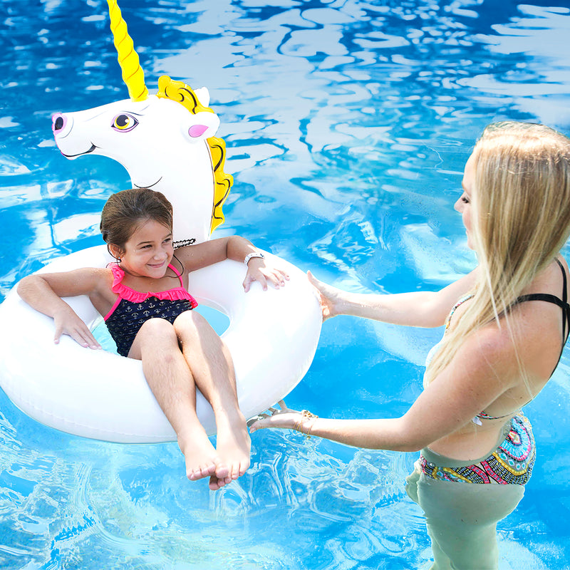 The girl is floating with Wham-O Splash Unicorn Pool Float