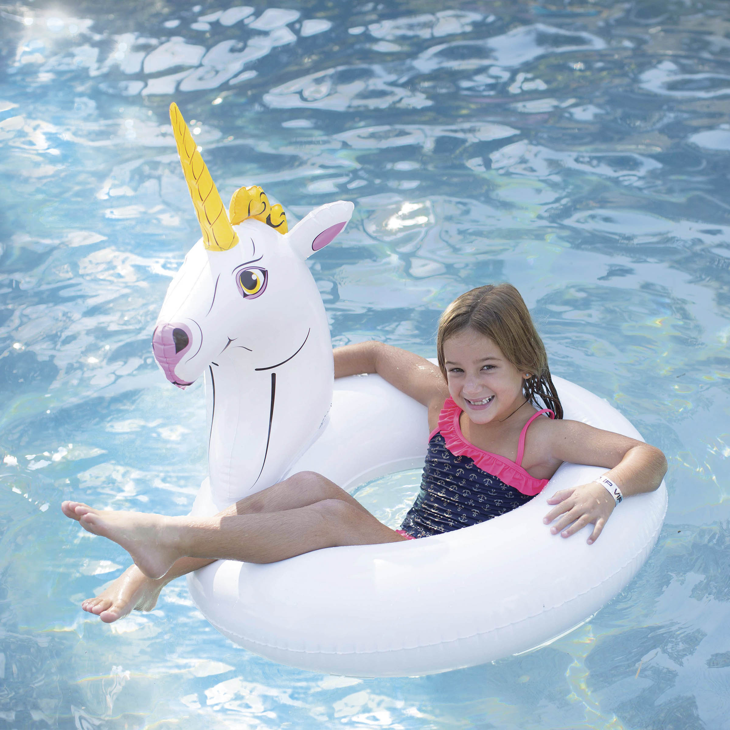 The girl is floating with Wham-O Splash Unicorn Pool Float