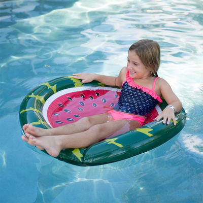 Children is floating with Wham-O Splash Watermelon Pool Float