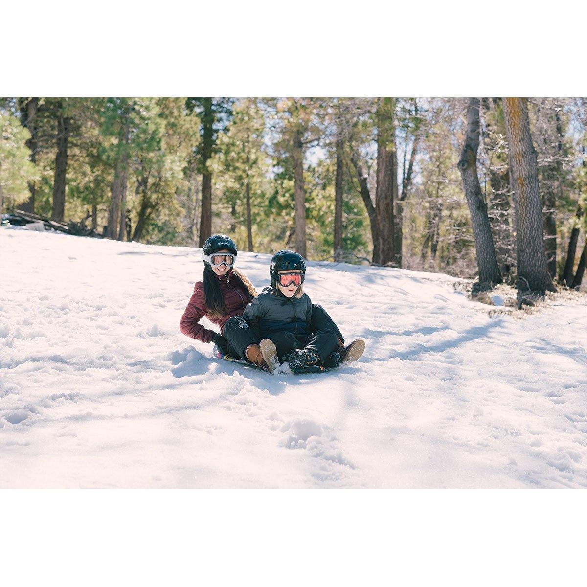 Children are sliding down the snow hill with Wham-O Snowboogie® Alpine Rocket 48"