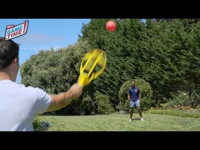 Two men are playing with Wham-O Game Time! Trac-Ball® Classic in the backyard happily